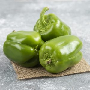 Green bell peppers on a piece of burlap. High quality photo